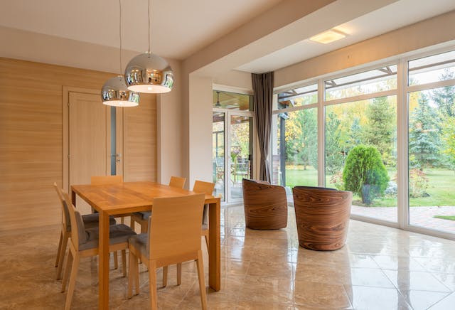 A photo of two pendant lights hanging above a dining table